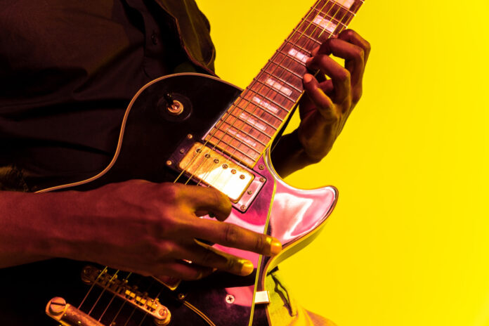 African American playing guitar